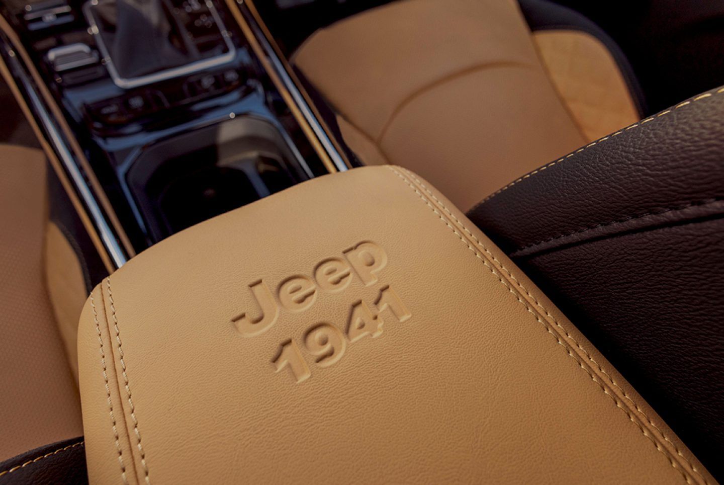 Jeep Meridian — Centre-armrest lid embossed with the Jeep 1941 heritage mark in tan leather.