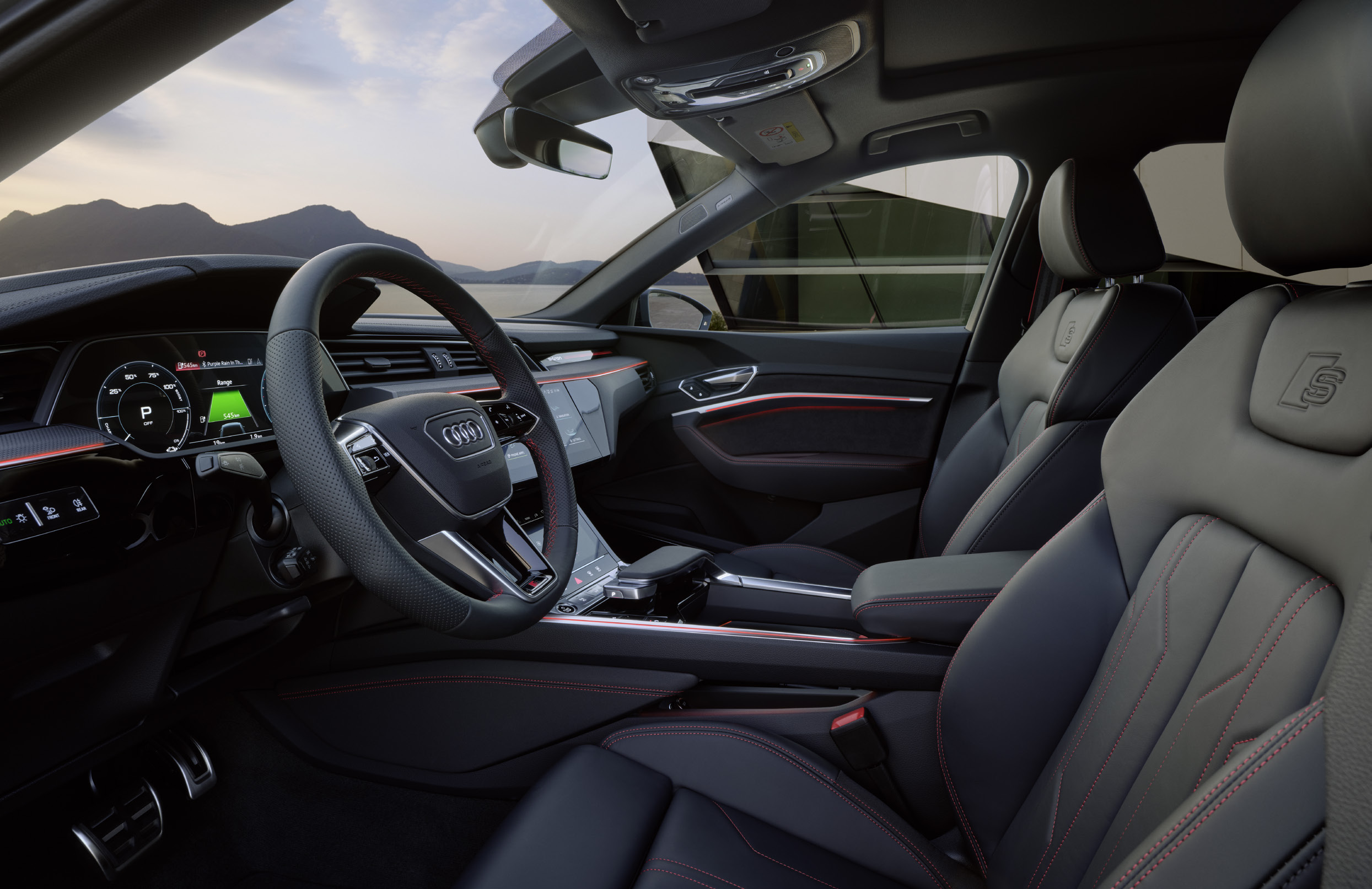 Audi Q8 e-tron — S line cabin with sport front seats, red contrast stitching and the Audi virtual cockpit driver display.