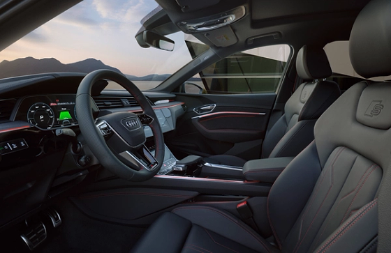 Audi Q8 e-tron, S line cabin with sport front seats, red contrast stitching and the Audi virtual cockpit driver display.