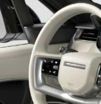 Land Rover Range Rover — Perlino leather multifunction steering wheel with piano-black touch controls.