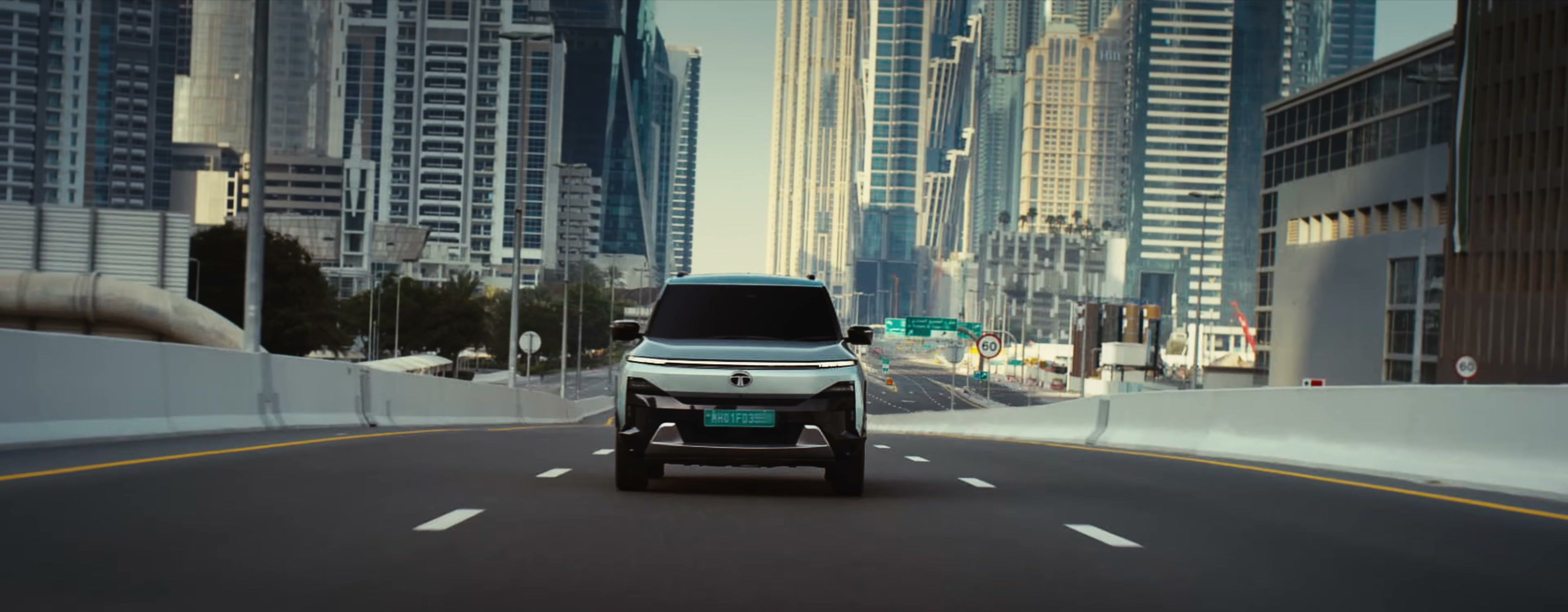 Tata Sierra.ev driving head-on through the Dubai skyline