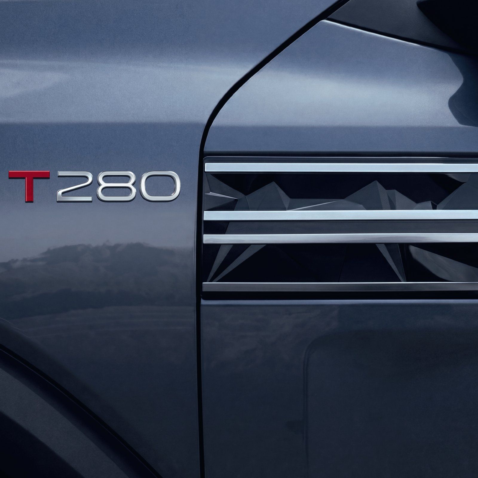 Nissan Tekton — T280 badge with chrome-slatted fender vent garnish
