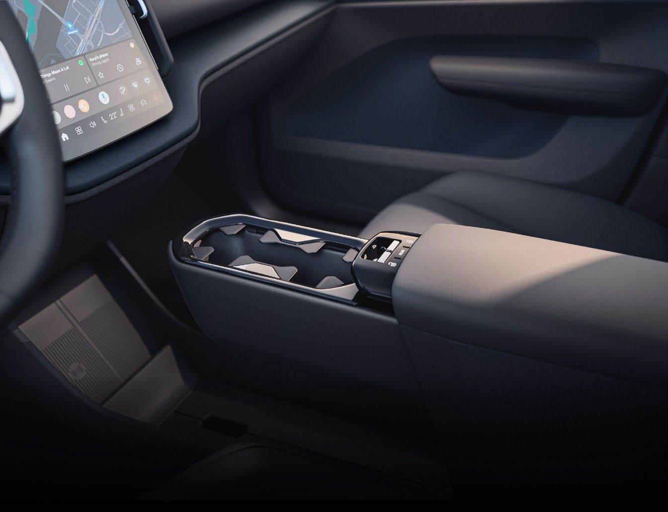 Volvo EX30 — Centre console between the front seats with open storage and cup-holders.