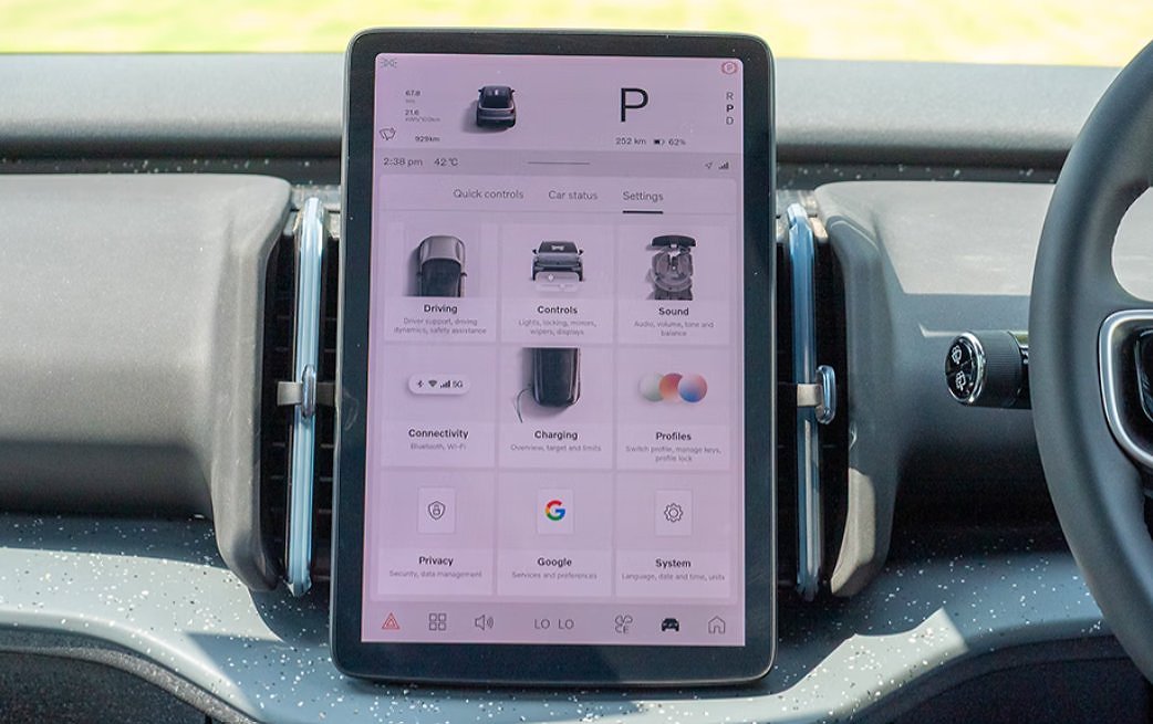 Central touchscreen display in car interior showing vehicle settings and control menu.