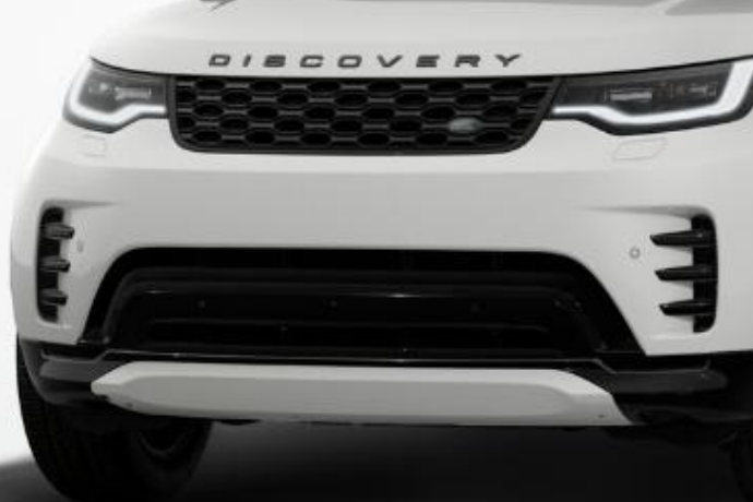 Land Rover Discovery — Sculpted front bumper with vertical air intakes and a silver front skid plate.