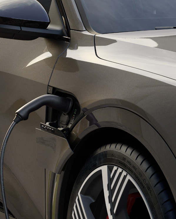 Audi Q8 e-tron — Charging connector docked into the e-tron charge port beside the front wheel.