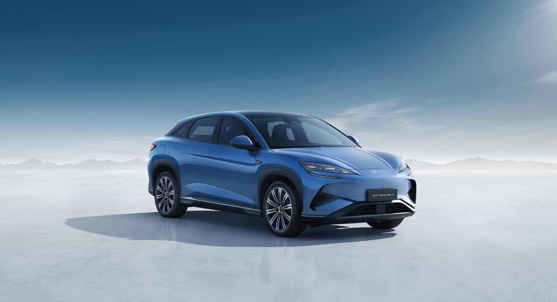 BYD Sealion 7 — Front three-quarter studio profile of the coupe-SUV silhouette.