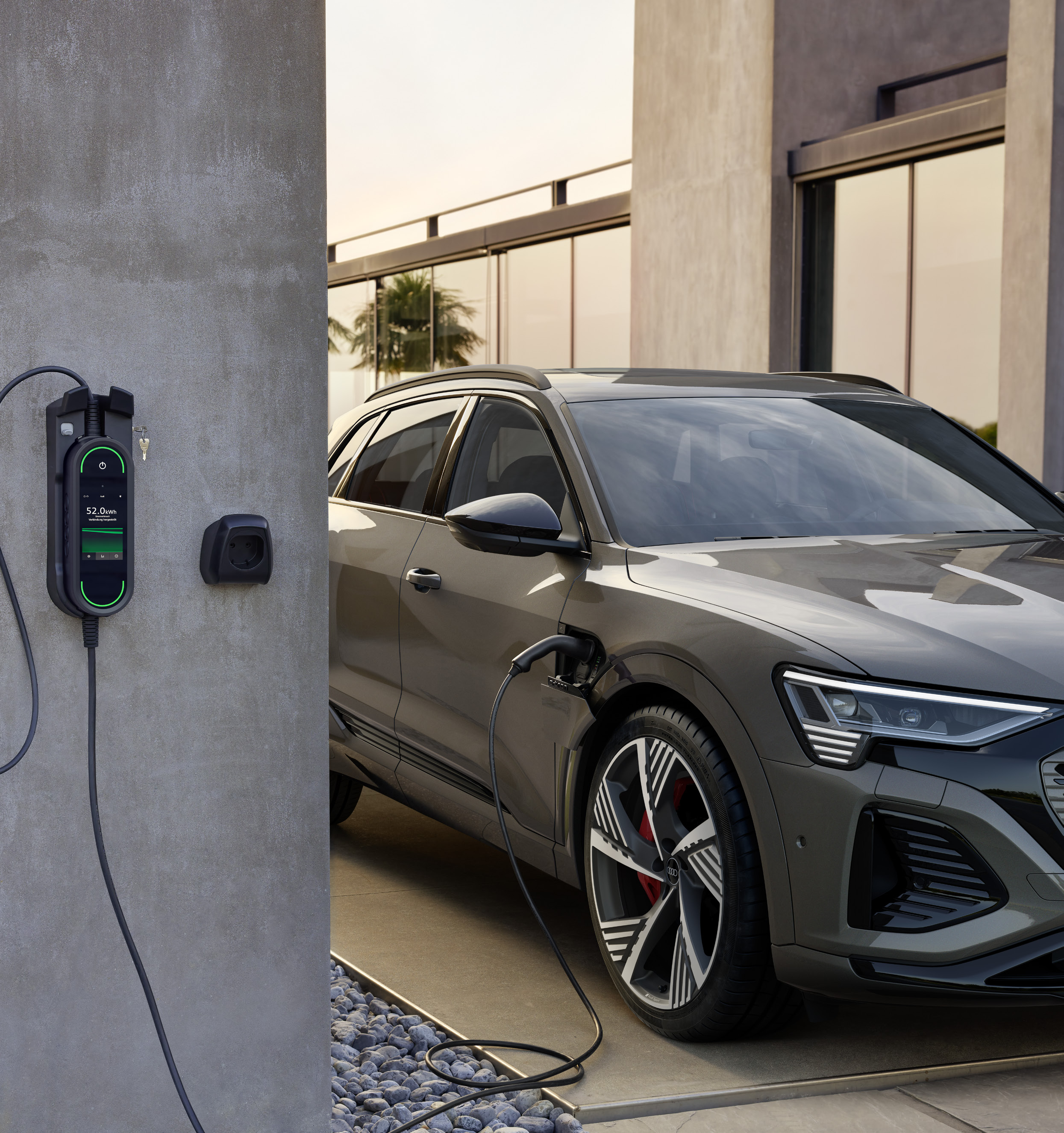 Audi Q8 e-tron — Home AC charging using the compact charging system, with the charge port on the front wing.