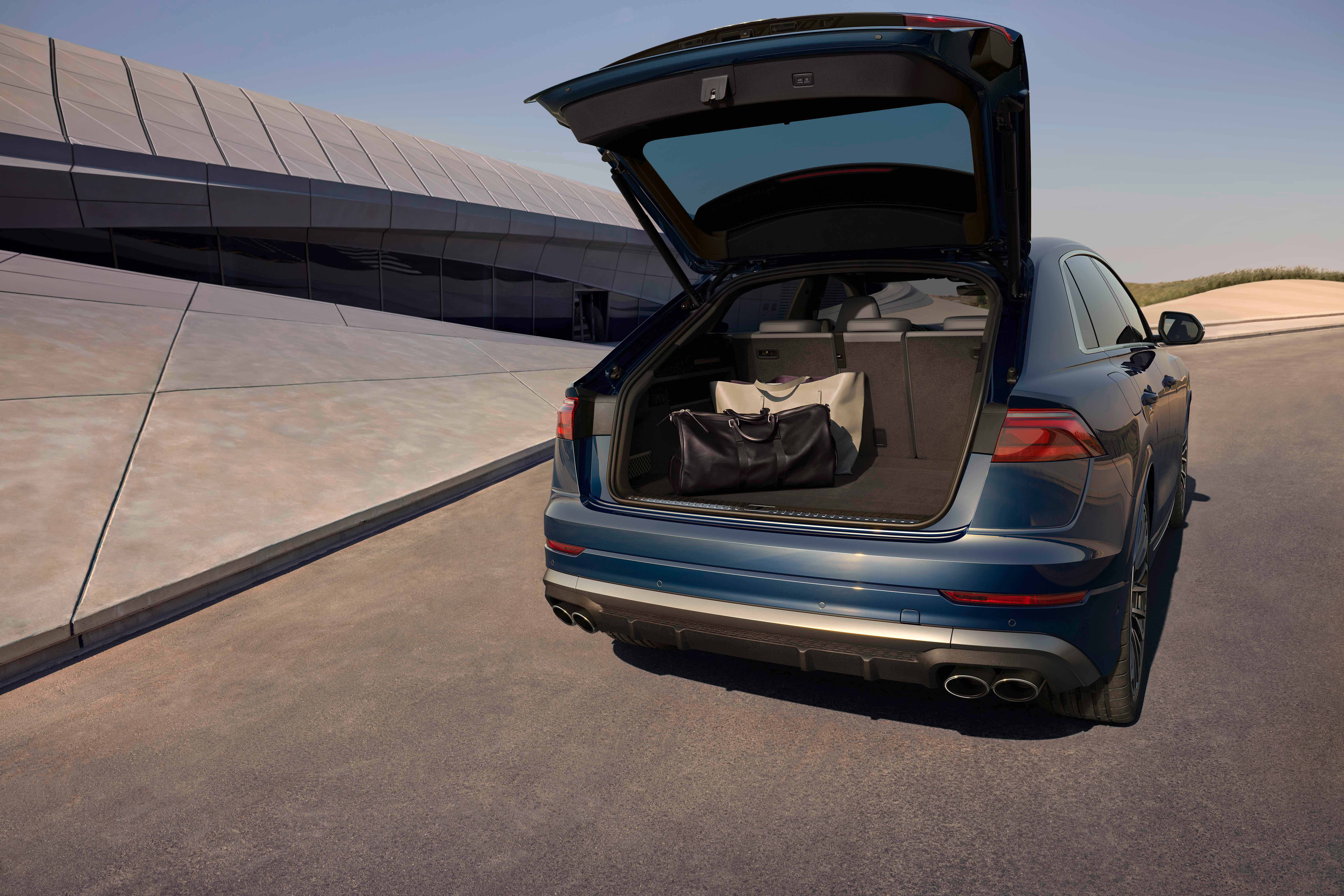 Audi SQ8 — Power tailgate opening to a wide luggage compartment.