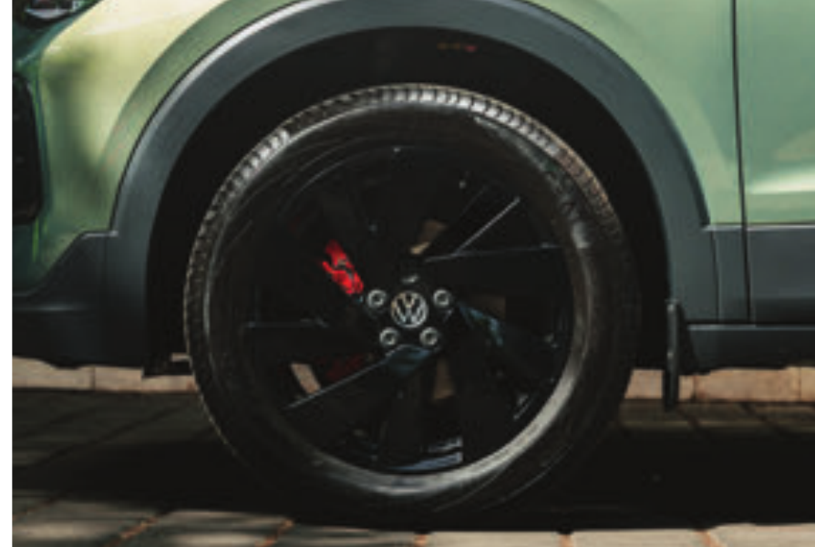 Volkswagen Taigun — Glossy black diamond-cut alloy wheel with red brake caliper
