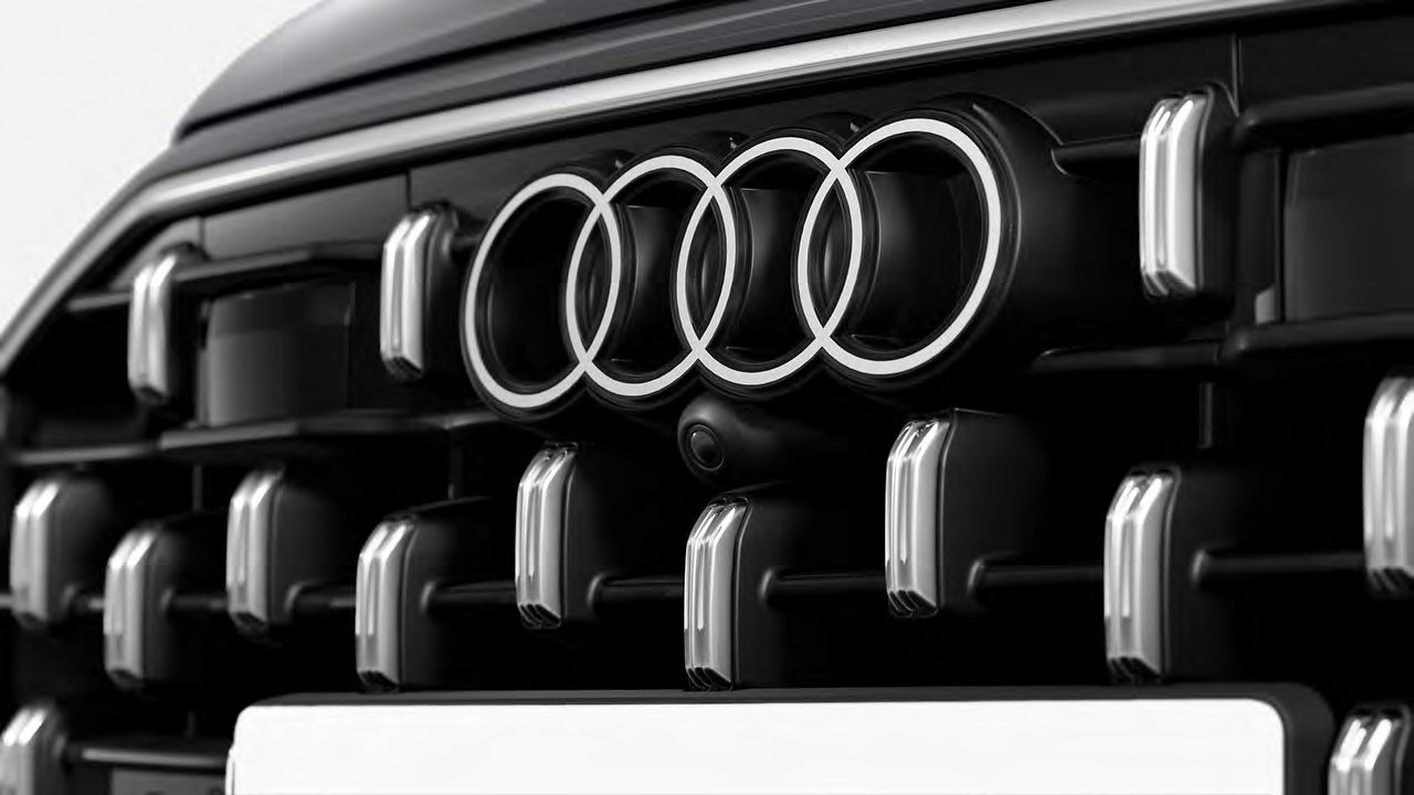 Audi Q8 — 2D Audi four-ring emblem set into the black single-frame grille.