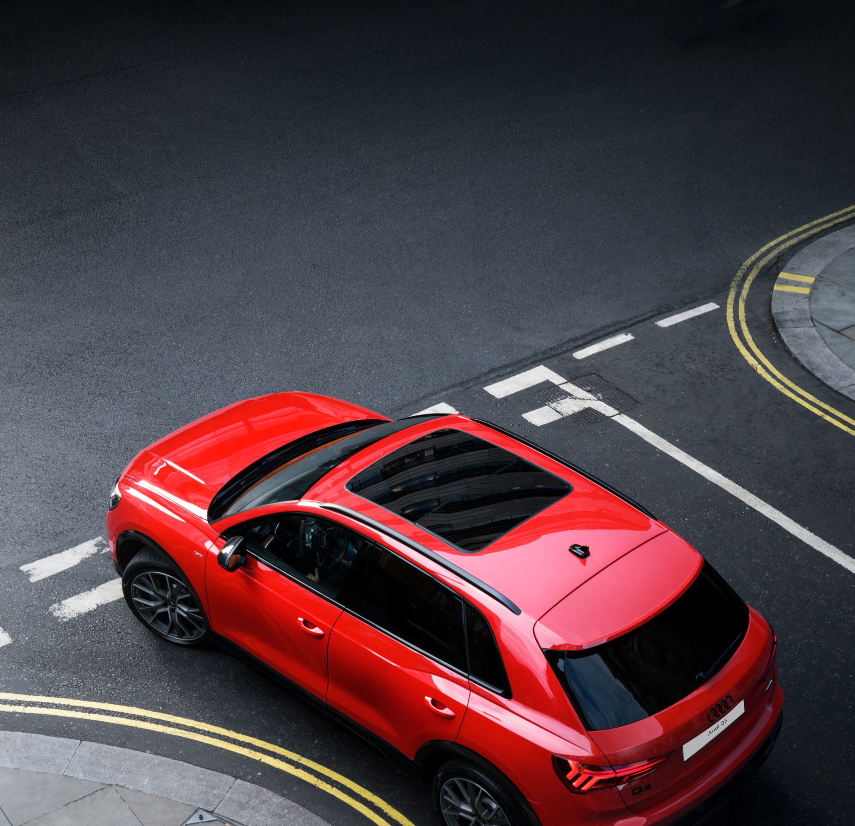 Audi Q3 — Panoramic glass roof seen from above, spanning the front of the cabin.