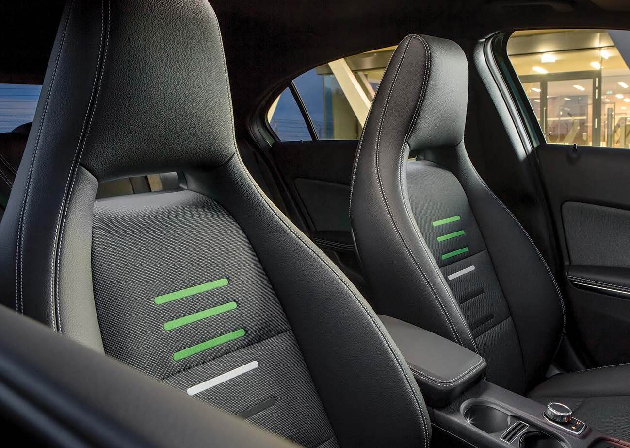 Mercedes-Benz Mercedes-AMG A45 S — Sports seats with contrasting green upholstery accents and honeycomb-look fabric.