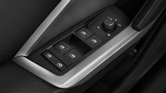 Audi Q3 (2022-2026), Driver-door switch panel with power window controls and rotary mirror-adjust selector.