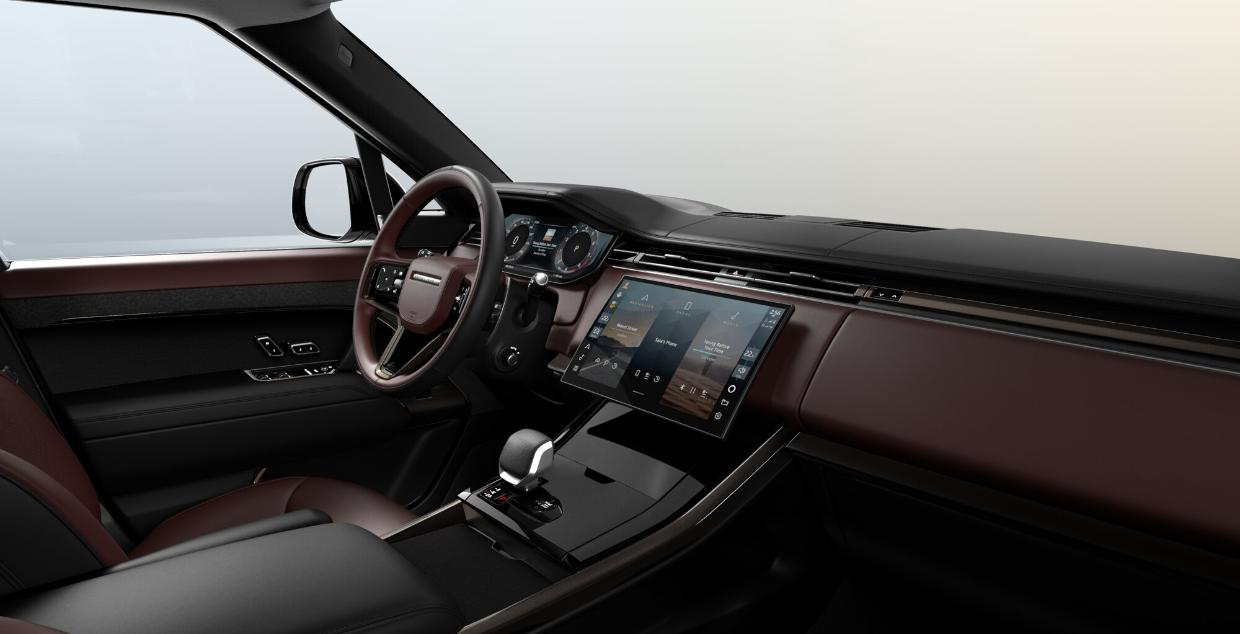 Land Rover Range Rover Sport — Driver-focused cabin with the curved Pivi Pro touchscreen, digital instrument cluster and Deep Garnet/Ebony Windsor leather.