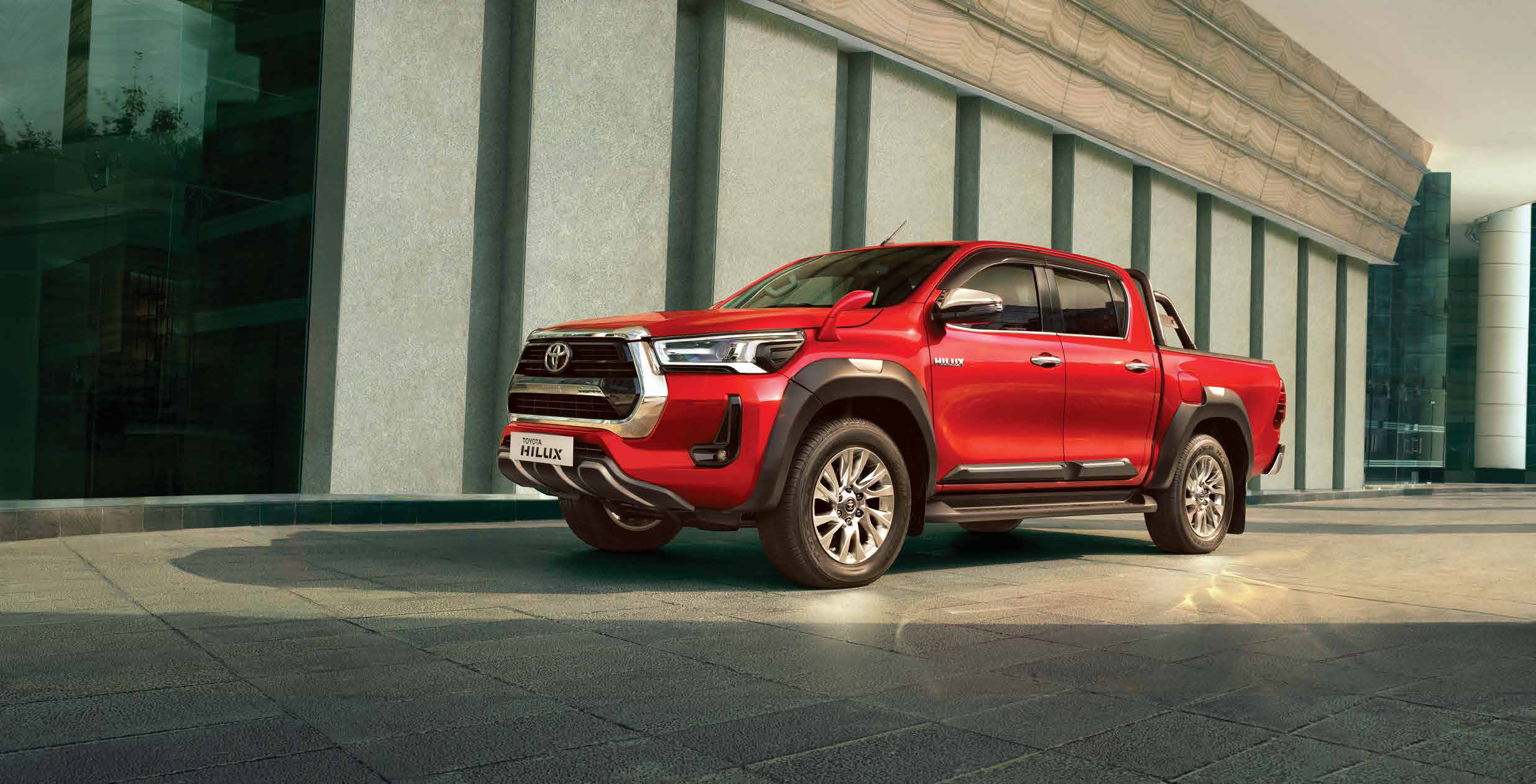 Toyota Hilux — Muscular double-cab profile riding on machined-finish alloy wheels.