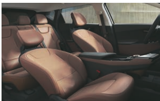 Kia EV6, Driver and front-passenger premium relaxation seats in tan upholstery.