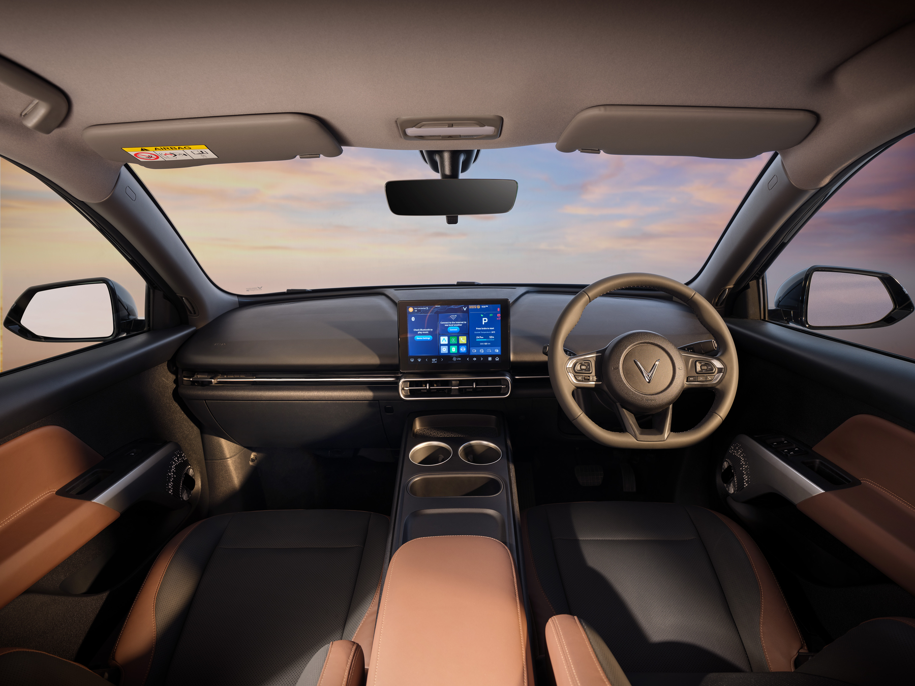 VinFast VF MPV 7 — Driver-focused cockpit with leather-wrapped steering wheel and dual-tone upholstery