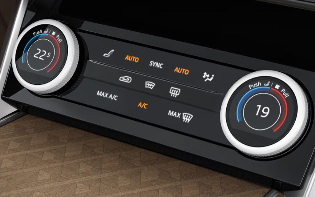 Dual-zone climate control panel with temperature dials set to 22.5 and 19 degrees.
