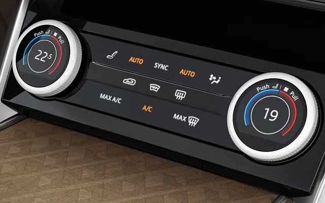 Dual-zone climate control panel with temperature dials set to 22.5 and 19 degrees.
