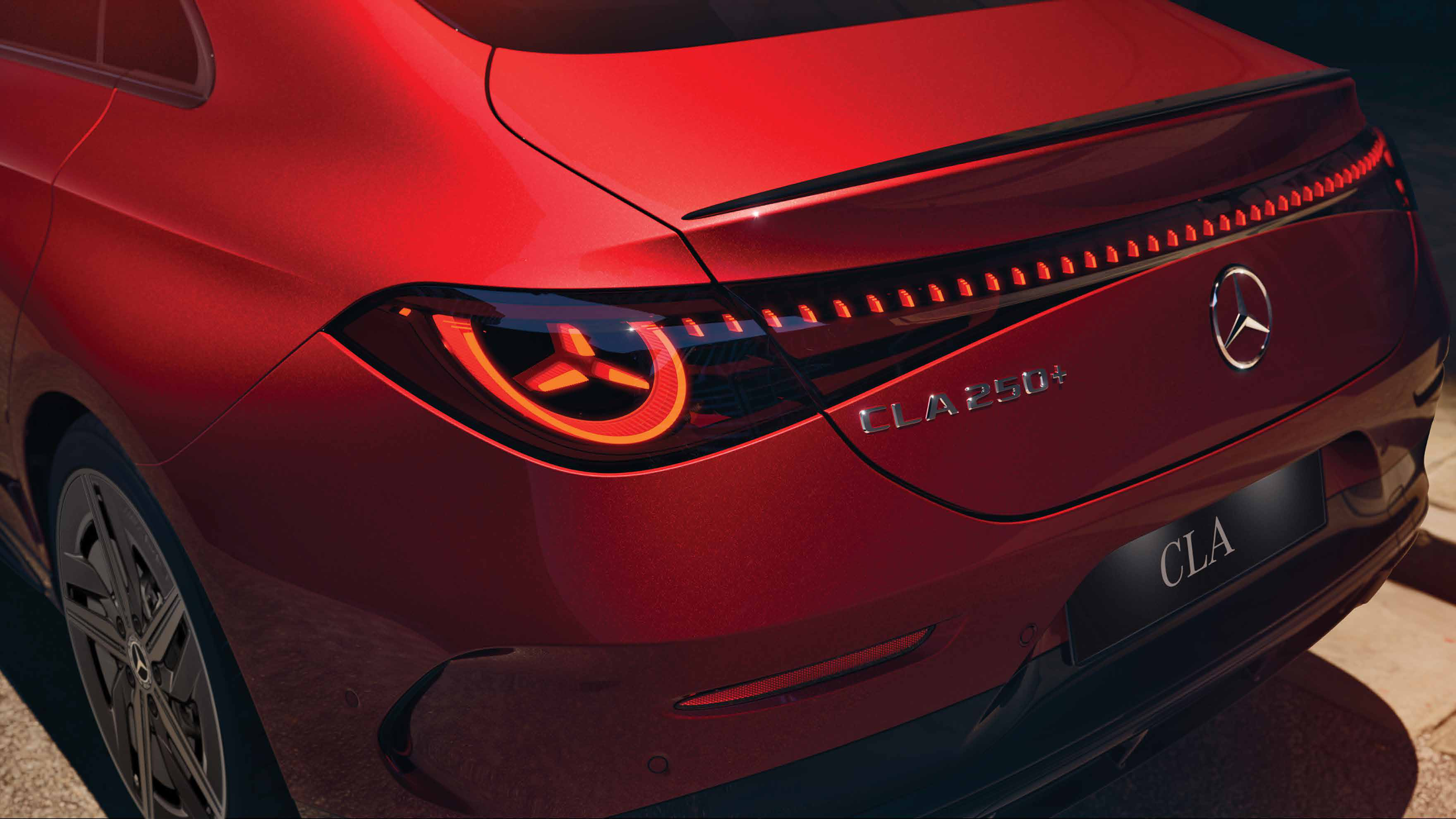 Mercedes-Benz CLA Electric — Full-width light band connecting the two star-shaped LED tail lamps.