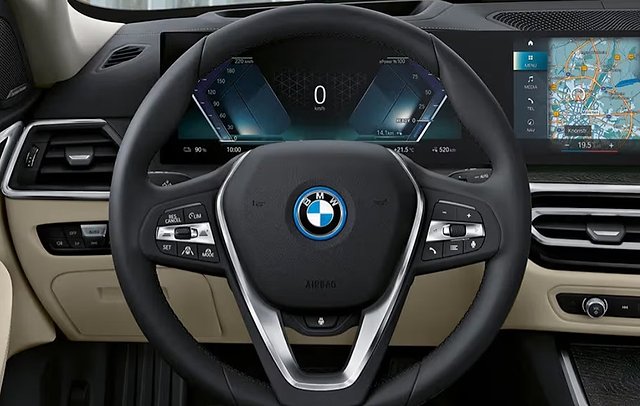 BMW i4 interior showing steering wheel, digital dashboard, and navigation display.