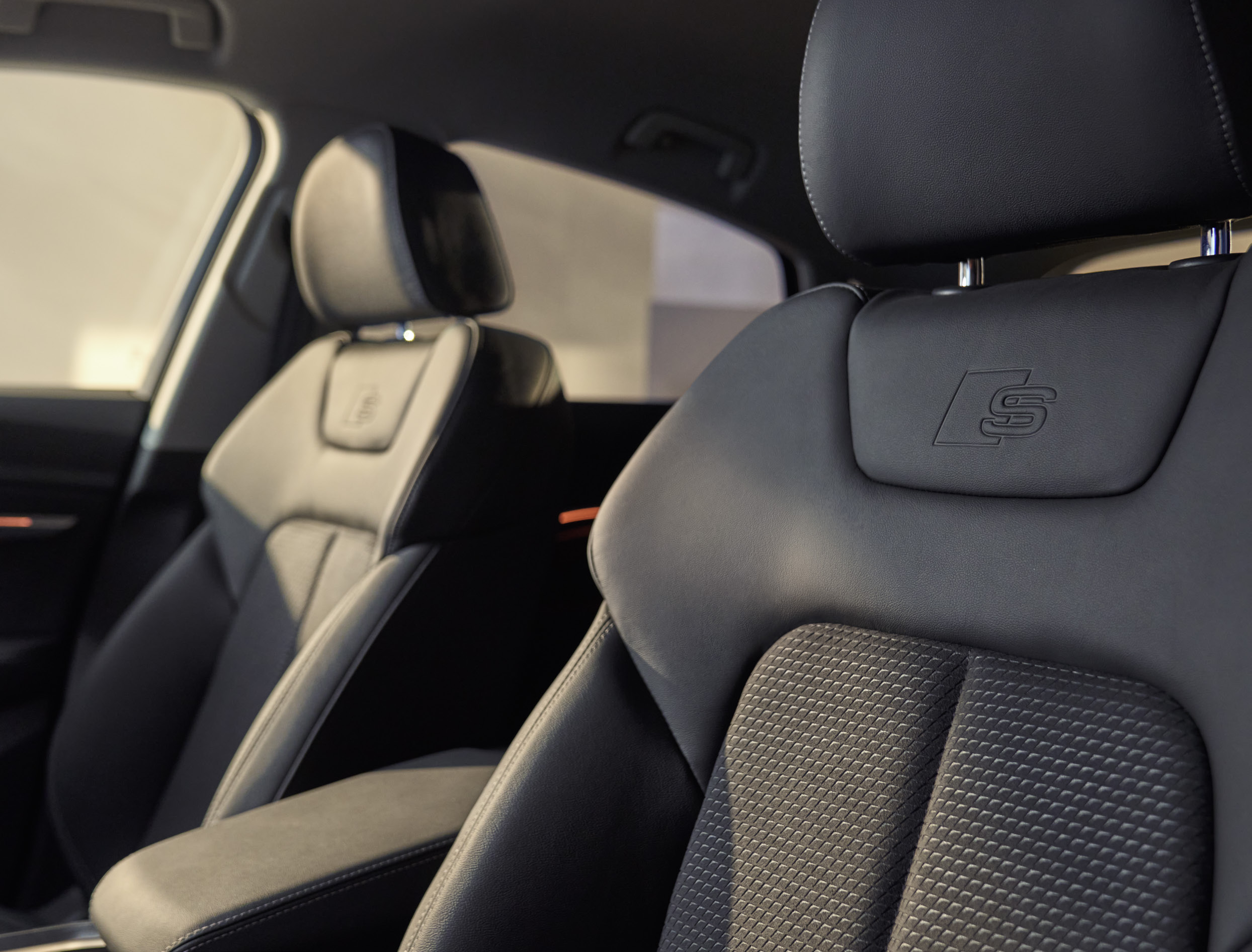 Audi Q8 Sportback e-tron — S line sport seats with embossed S logo on the headrests