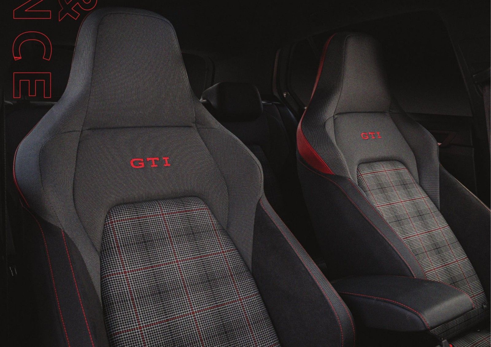 Volkswagen Golf GTI — GTI sport seats trimmed in the signature tartan-check pattern with red contrast stitching.