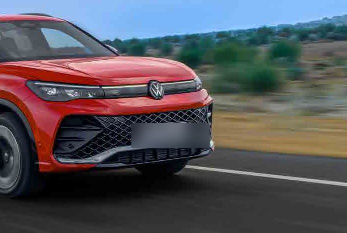 Volkswagen Tiguan R-Line — R-Line sports grille with black honeycomb insert flanked by LED headlamps and a full-width illuminated light band