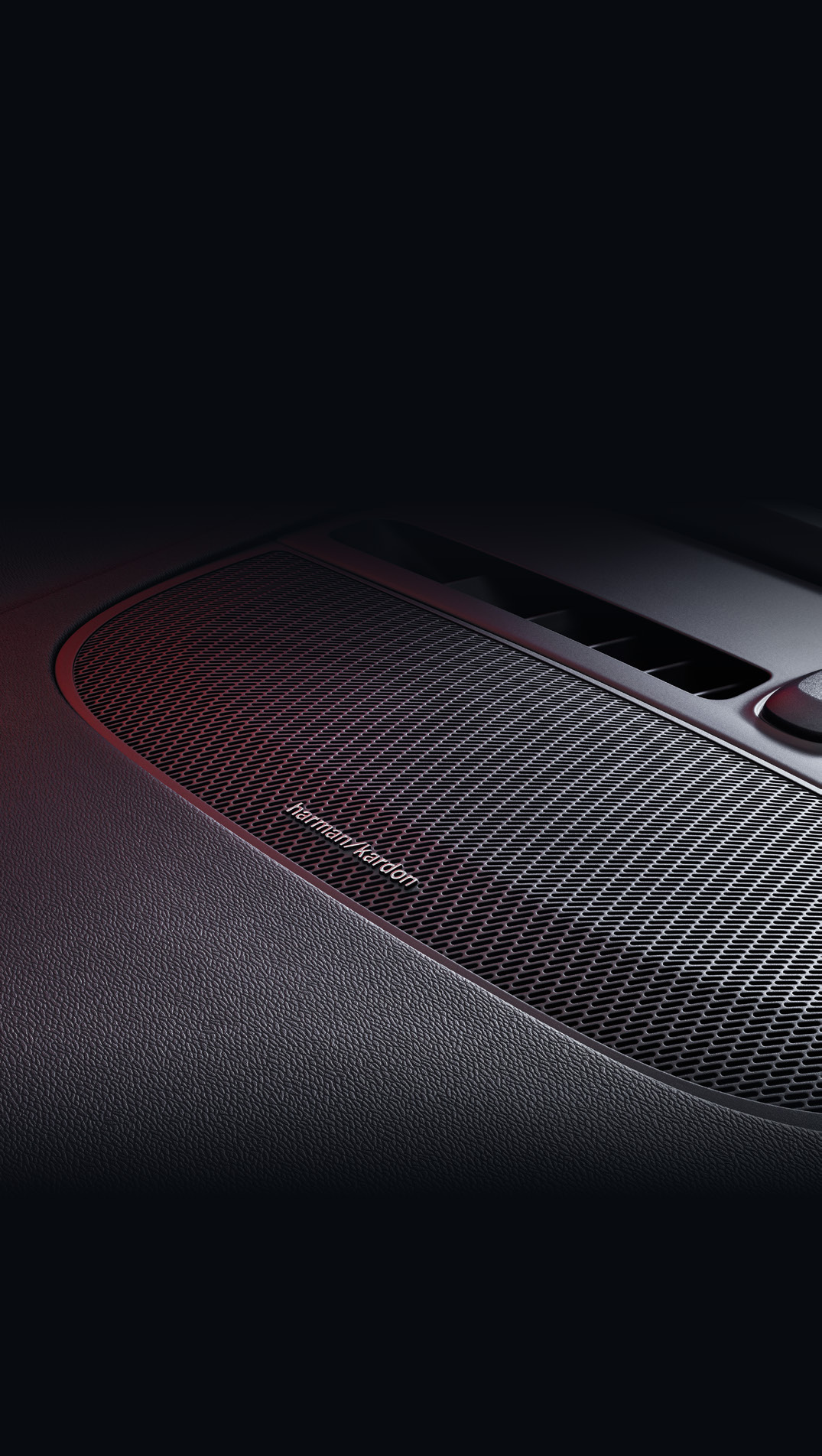 Volvo EC40 — Harman Kardon premium sound system speaker grille integrated into the dashboard.