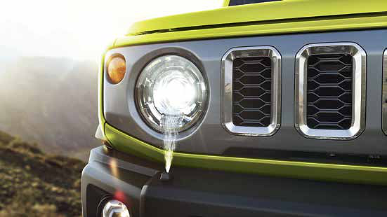 Maruti Suzuki Jimny, Round LED projector headlamp sits beside the vertical-slot honeycomb grille.
