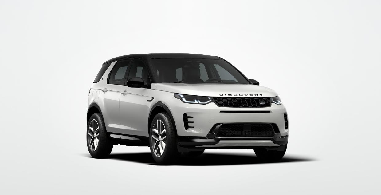 Land Rover Discovery Sport — Front three-quarter view showing the signature LED headlights and Discovery grille lettering, finished in Fuji White with a black contrast roof.