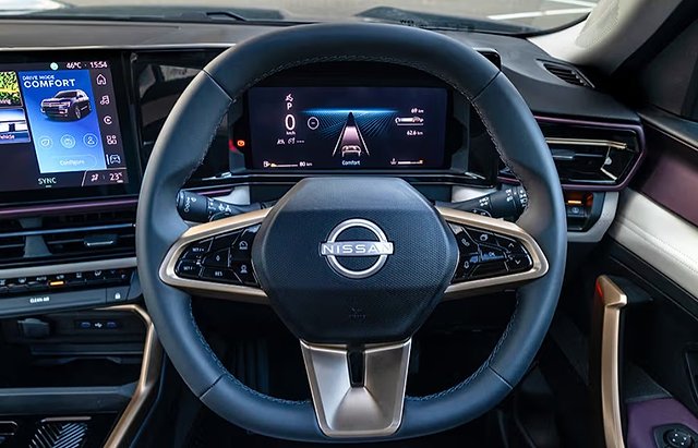 Nissan steering wheel with digital dashboard display and center console infotainment system.