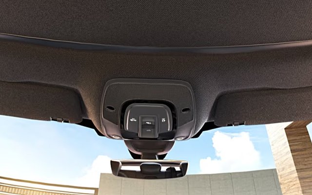Overhead interior panel with buttons for sunroof and lighting controls.