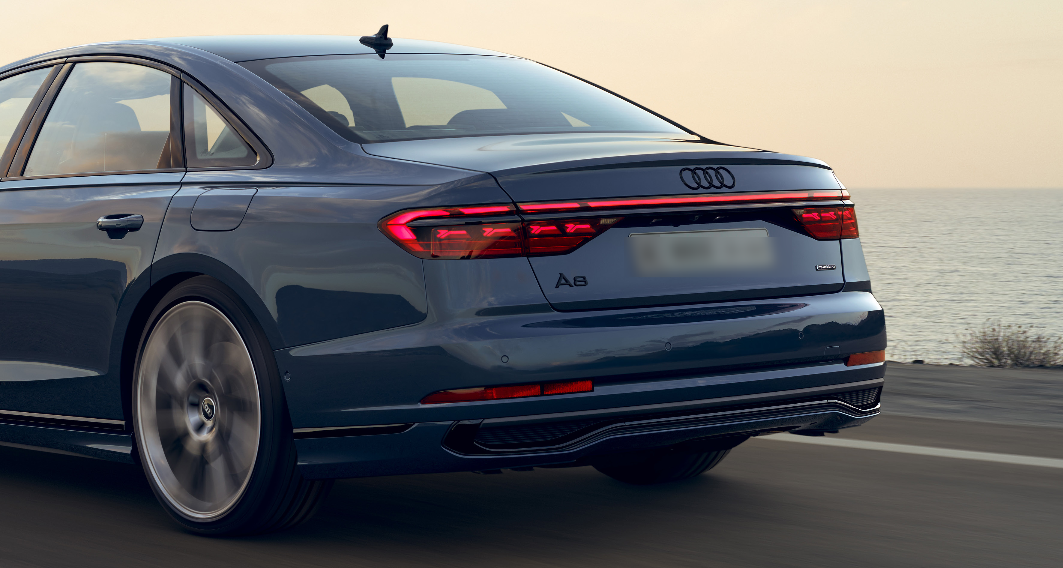 Audi A8 L — Full-width connected LED rear light bar with quattro badging and rear diffuser