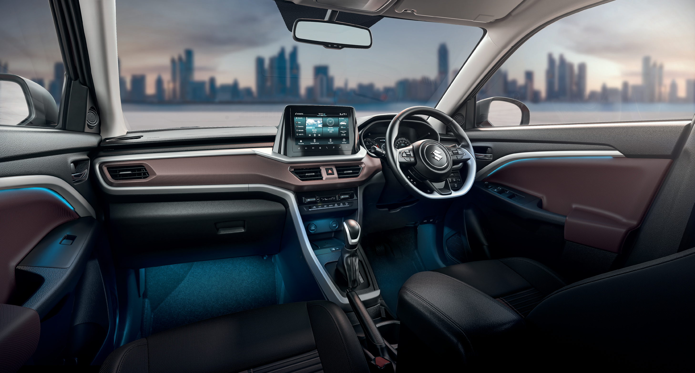 Maruti Suzuki Brezza — Dual-tone black and brown cabin with silver accents, ambient lighting and floating touchscreen.