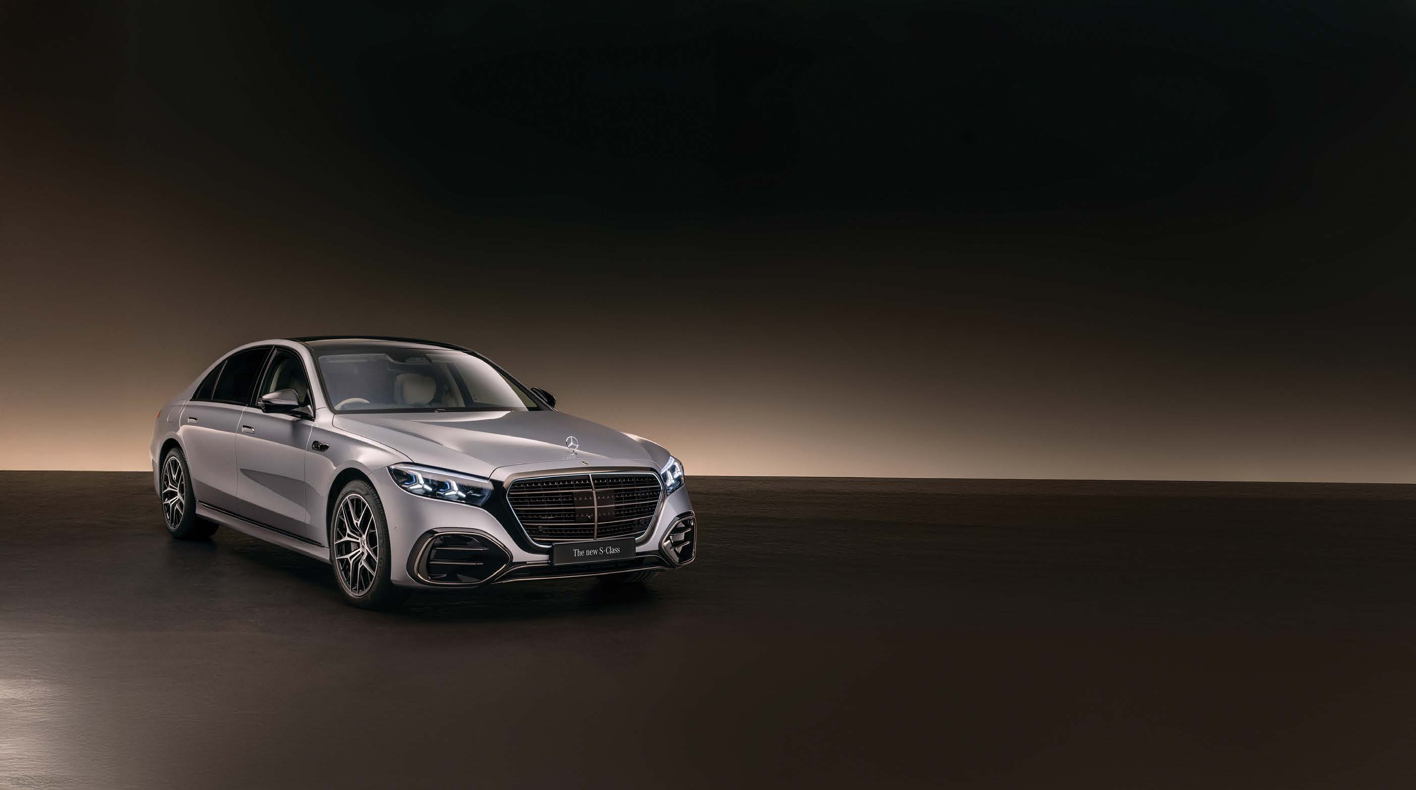 Mercedes-Benz S-Class — The new S-Class in a front three-quarter studio view, with AMG Line front apron and multi-spoke alloy wheels