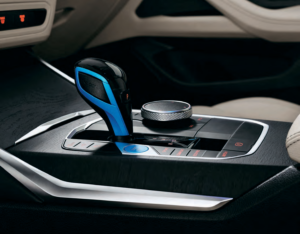 BMW i4 — Centre console control hub: electronic gear selector, iDrive rotary Controller, Start/Stop and driving-experience buttons.