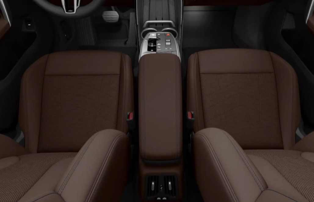 Brown leather and fabric front seats with center console in modern vehicle interior.