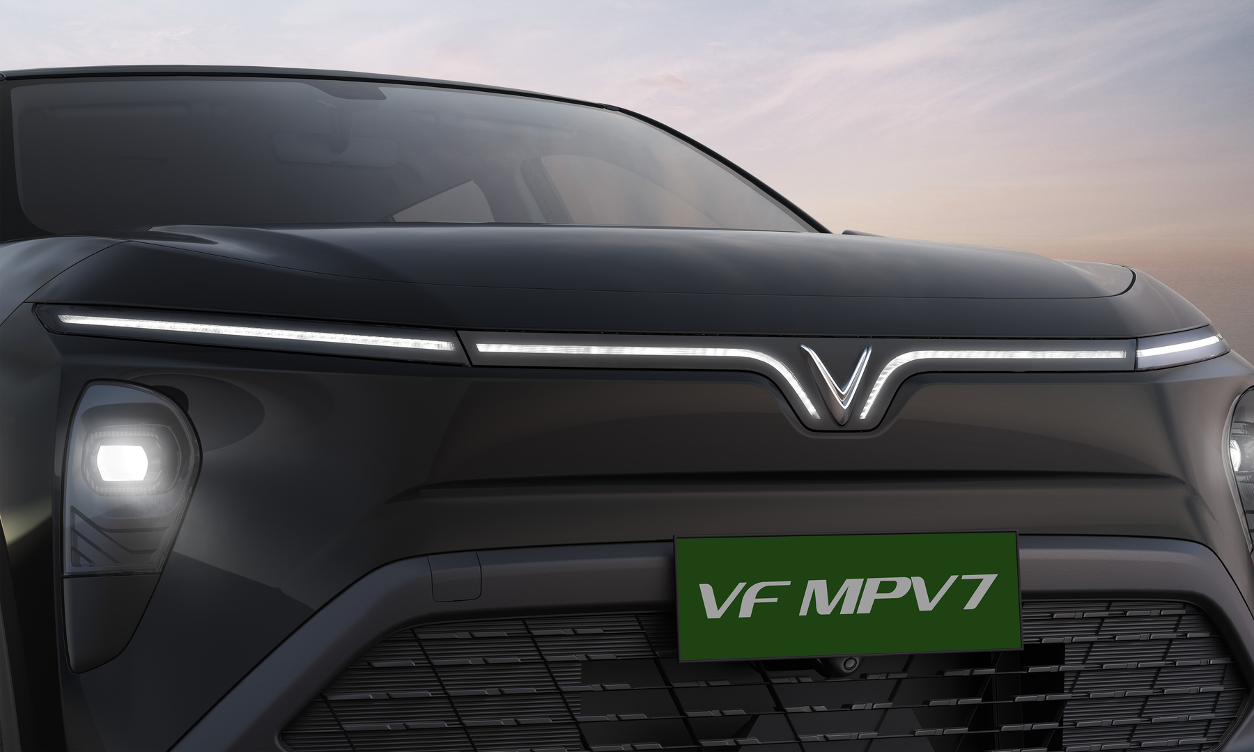 VinFast VF MPV 7 — Signature V-shaped LED light bar with connected daytime running lamps