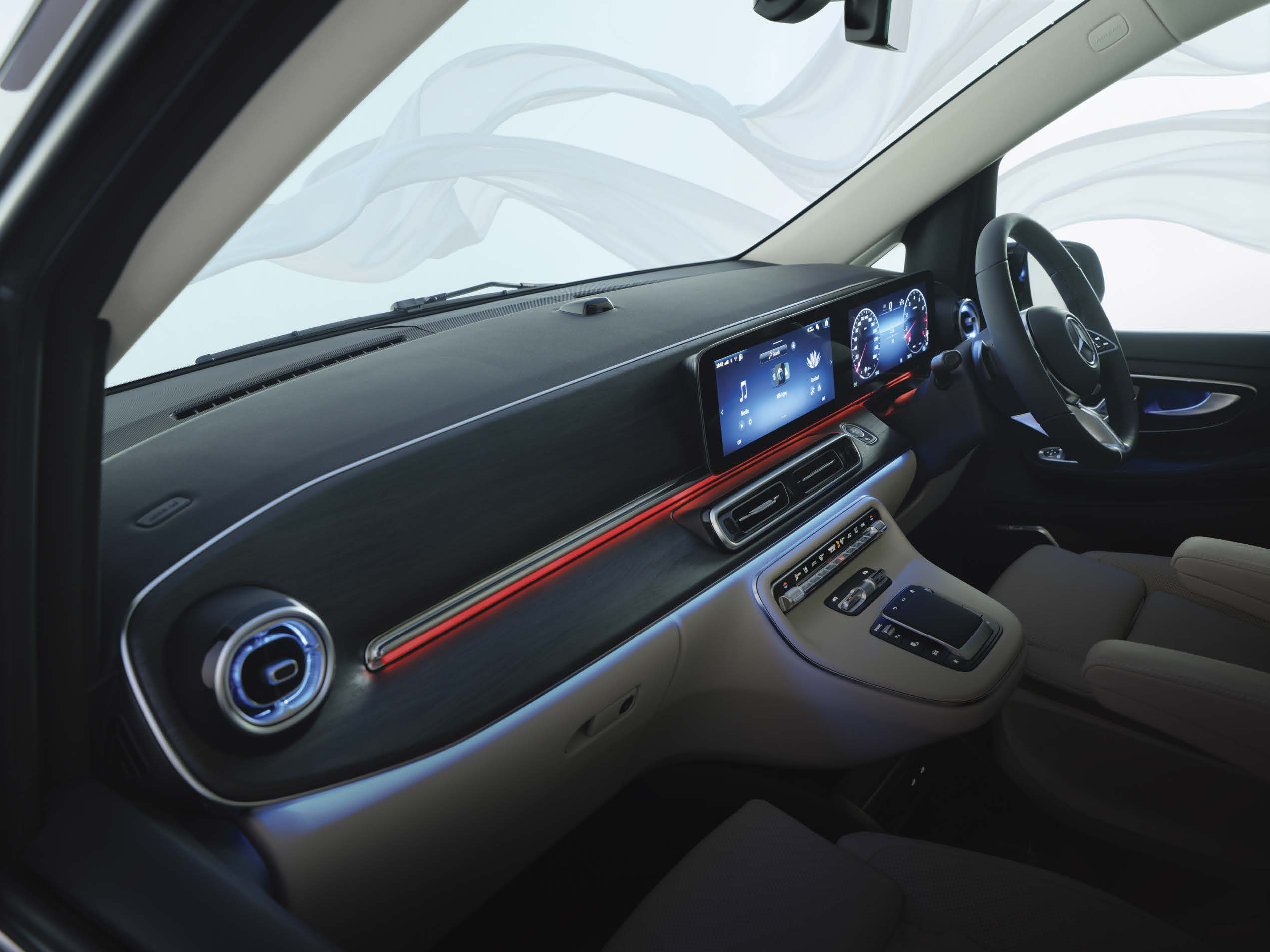 Mercedes-Benz V-Class — Open-pore wood-look trim flowing across the dashboard, paired with the free-standing MBUX media display and a red ambient light strip.