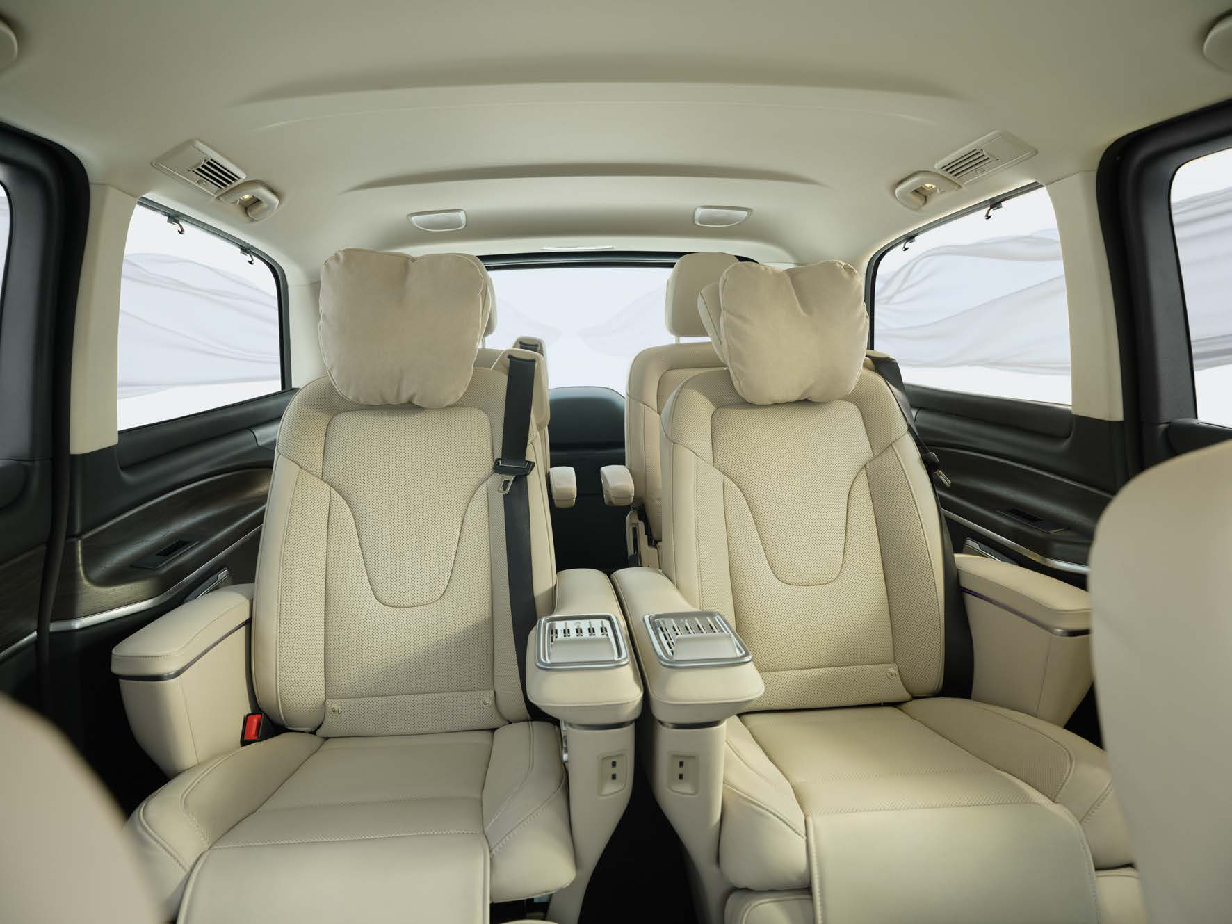Mercedes-Benz V-Class — Second-row luxury captain seats clad in Silk Beige Lugano leather with alpaca-grey stitching, integrated head cushions and deployable armrests.