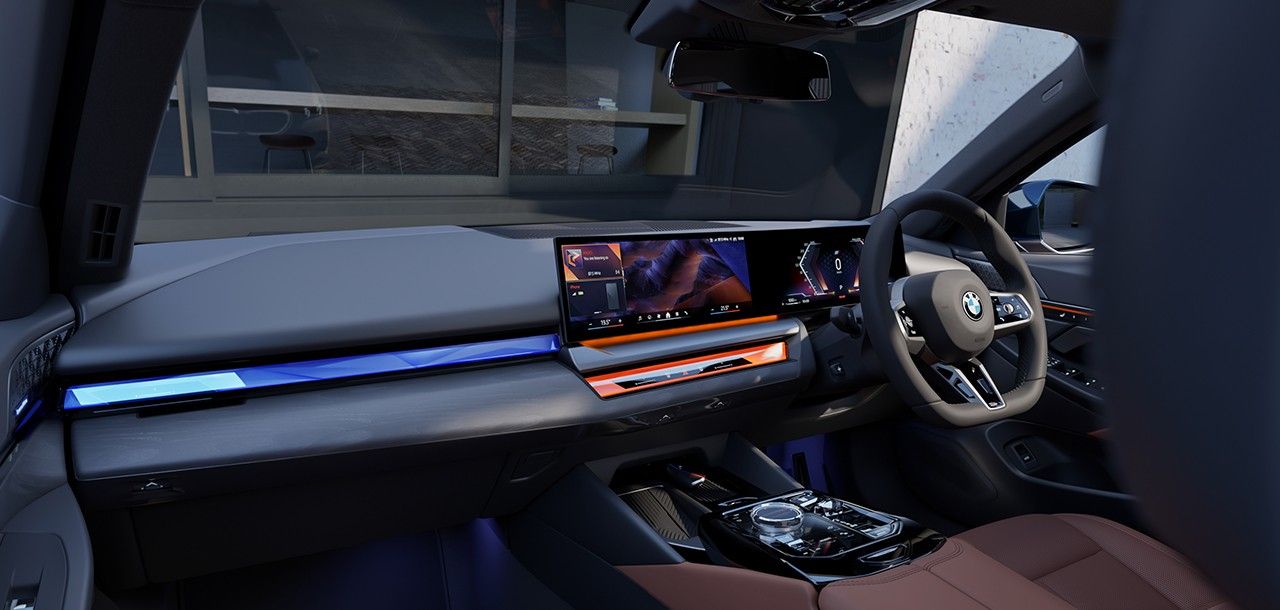 BMW i5 LWB — BMW Interaction Bar with ambient contour lighting across the dashboard and doors.