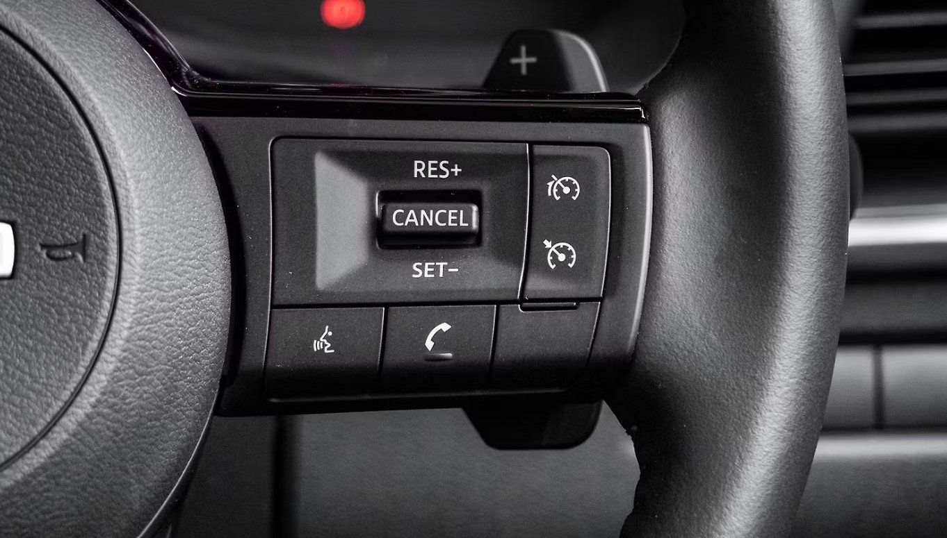 Steering wheel controls showing cruise control buttons: RES+, CANCEL, SET-, and phone functions.