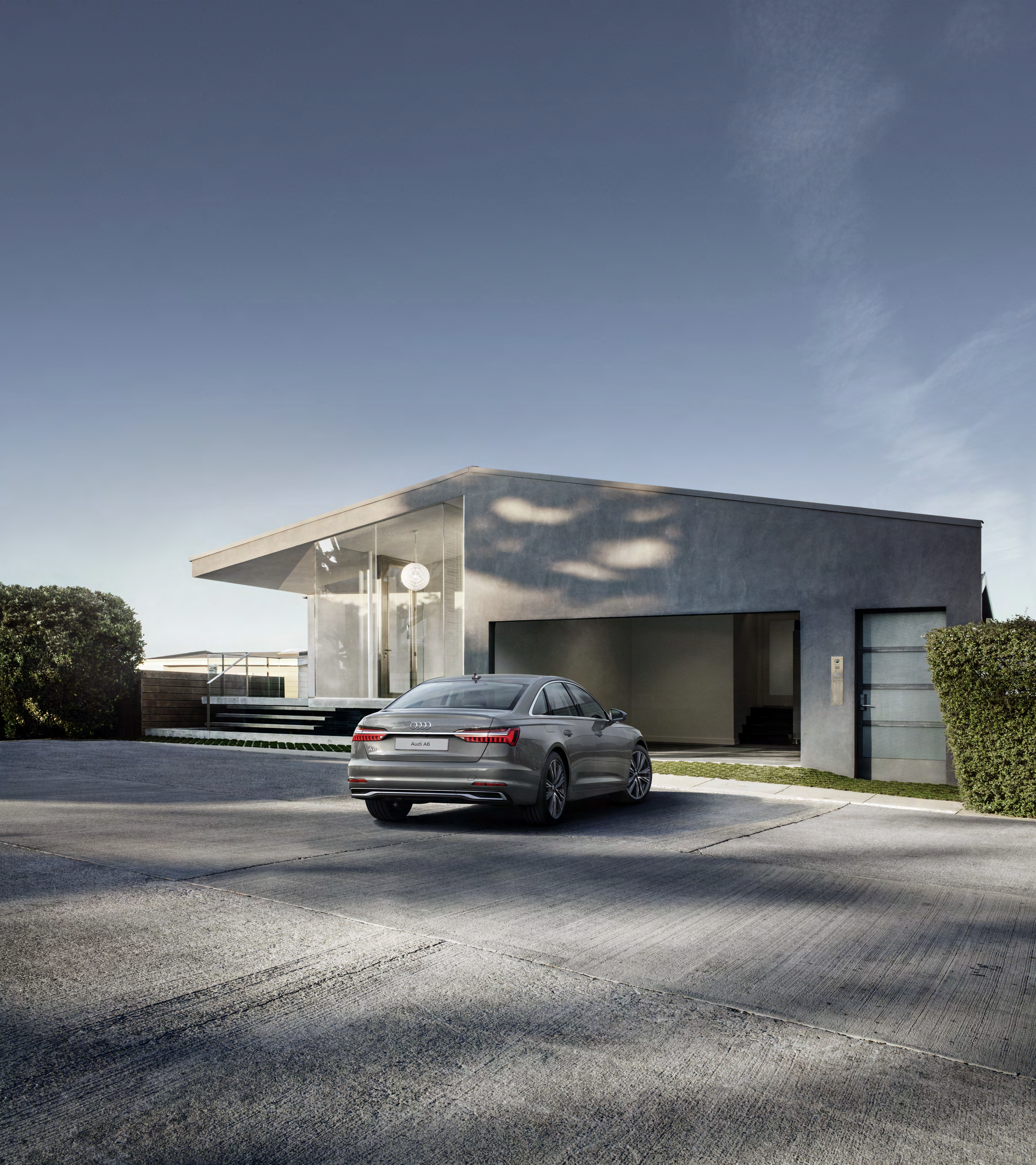 Audi A6 — Rear design with slim wraparound tail lamps and full-width chrome accent