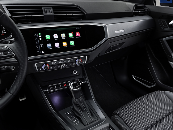 Audi Q3 (2022-2026), MMI touchscreen showing smartphone-mirrored apps above the two-zone climate controls.