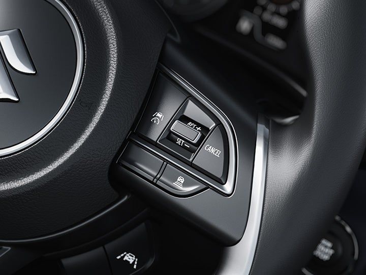 Maruti Suzuki Baleno — Suzuki Safety Sense on Alpha (O): 8 functions including adaptive cruise with curve speed reduction, forward-collision warning, lane-departure prevention and high-beam assist.