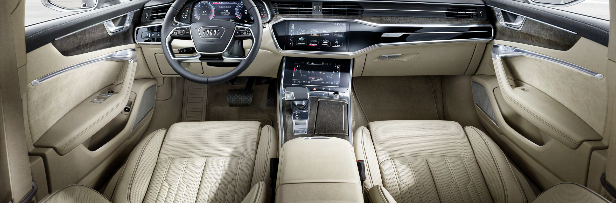 Audi A6 — Driver-oriented cabin with beige leather seats, wood inlay and twin displays