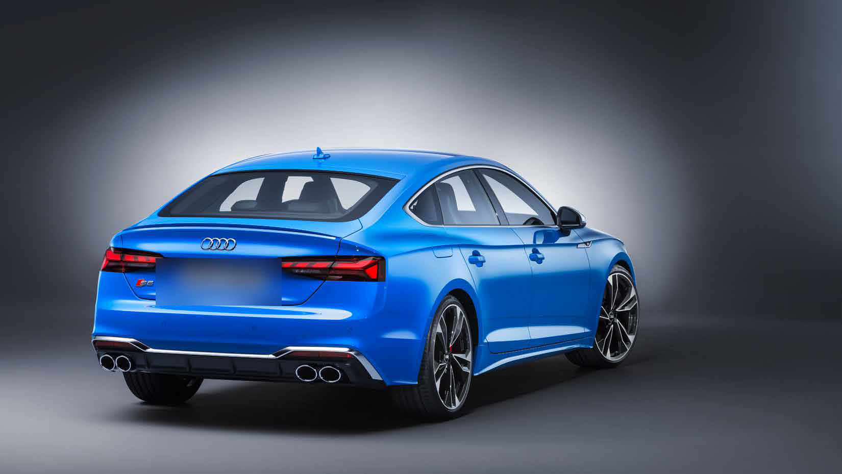 Audi S5 Sportback — S-specific rear diffuser framed by four chrome exhaust tailpipes