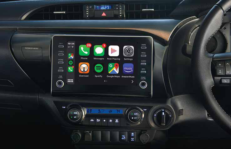 Toyota Hilux — Touchscreen with smartphone connectivity above dual-dial climate controls.